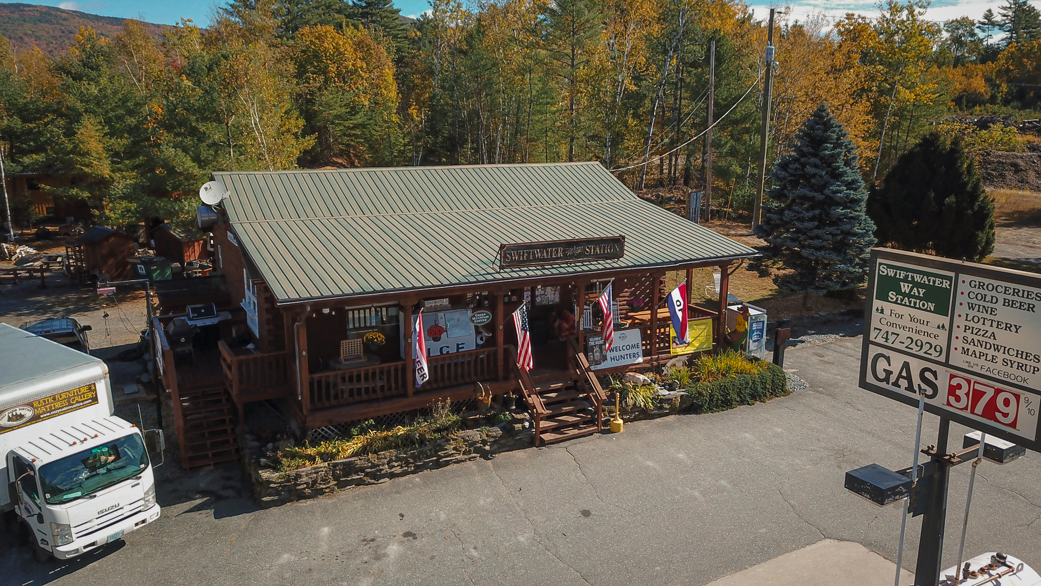 Swiftwater Way Station storefront with porch and flags in Bath NH